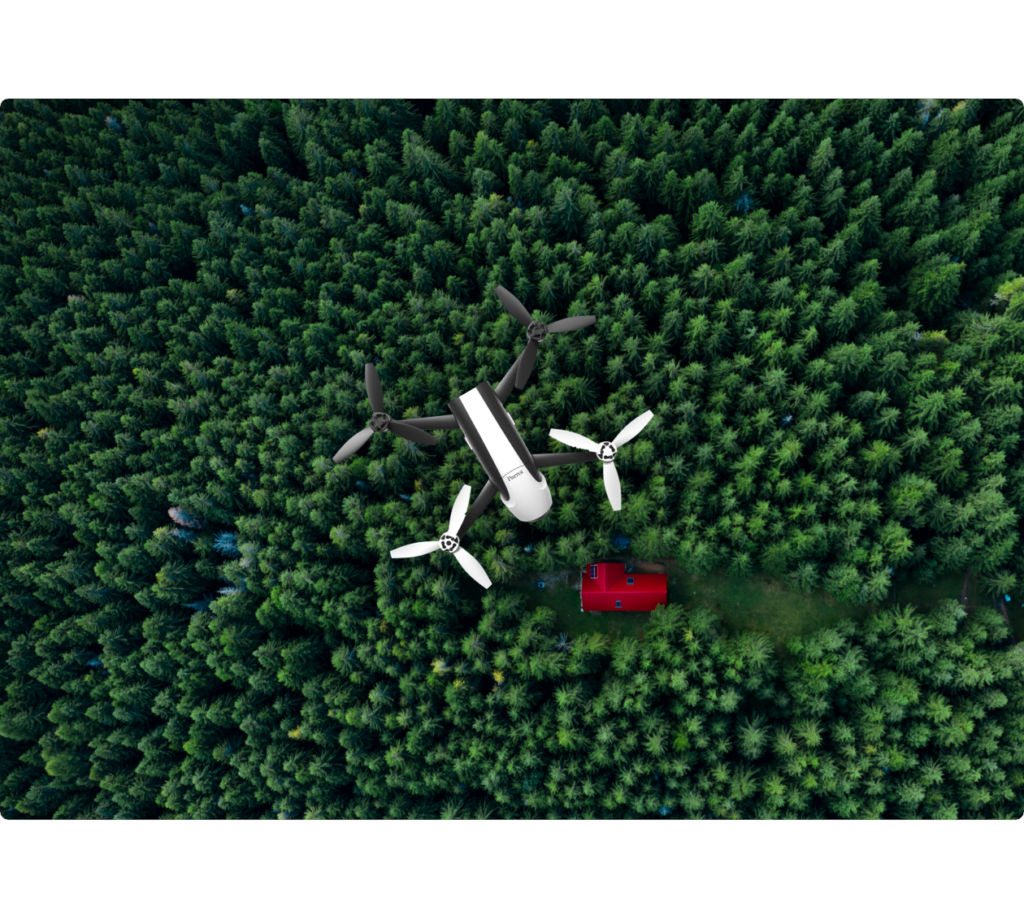 photo showing a view of a drone hovering over a forest capable of detecting smoke and fire